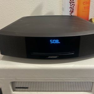 Bose wave music system.  Comes with remote also can turn off/on by touching top.